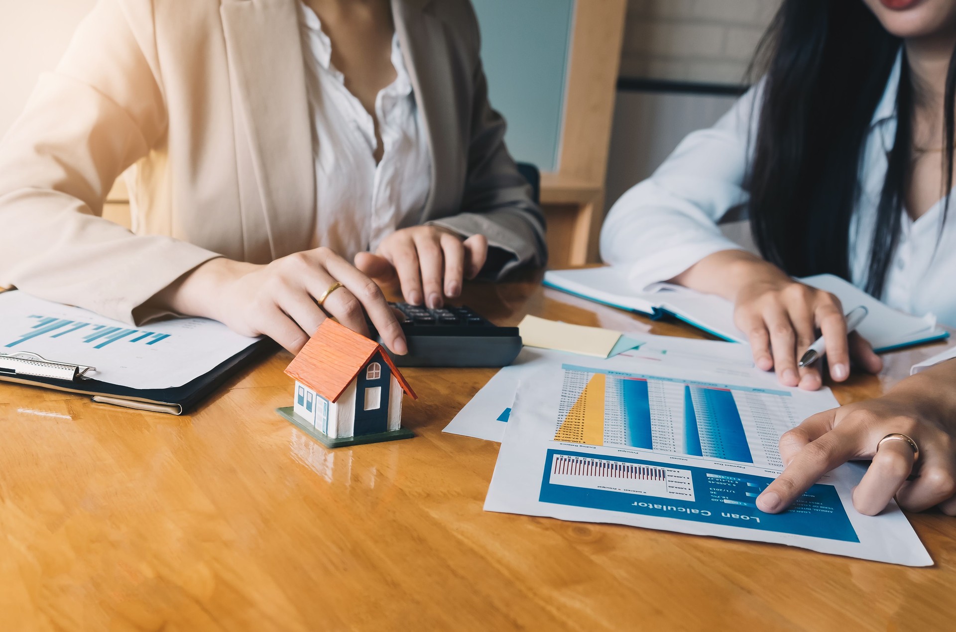 Real Estate Agent presenting and consult to customer to decision making sign insurance form agreement, concerning mortgage loan offer for and house insurance.