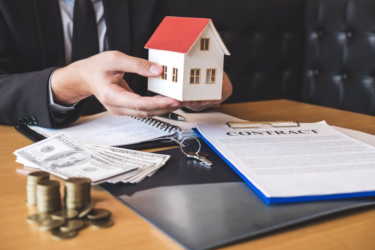 Estate agent sending house model to client after signing agreement contract real estate with approved mortgage application form, concerning mortgage loan offer for and house insurance.