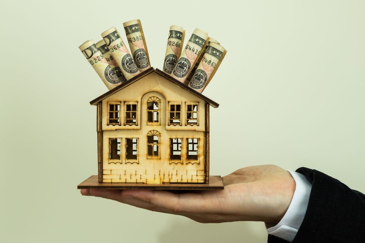 The hand keep the house with dollars for real estate and mortgage investment. Being an easy way homeowner. 